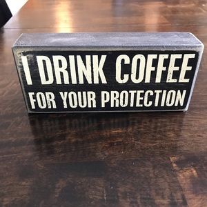 I drink coffee for your protection sign